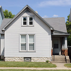 Close up of the front of a home with white vinyl siding