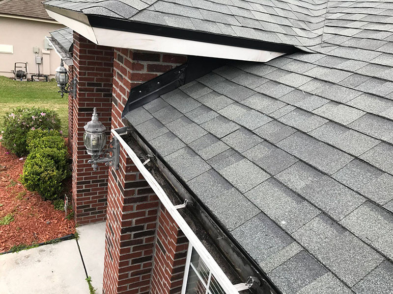 Close up of a residential roof with brand new gray shingles installed